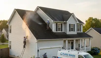 Technician cleaning roof and vinyl siding on Houston TX home for Next Level Exteriors service